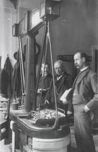 Weighing of silver, circa 1888