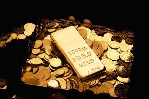 Gold bar atop gold coins