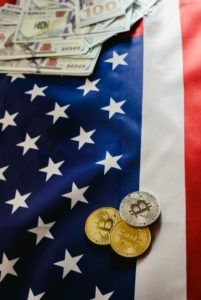  Bitcoin physical coins on American flag background with dollars 