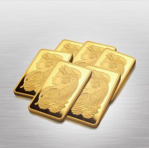 Stack of gold bars on mirrored background