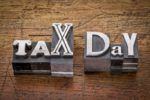 tax day - financial concept - words in mixed vintage metal type printing blocks over grunge wood