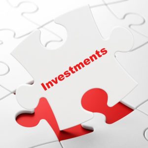 Investments on White puzzle pieces background