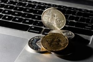 Several bitcoin coins with laptop keyboard background