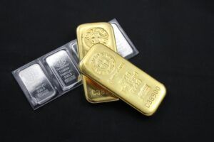 Gold and silver bars, stacked, on dark background