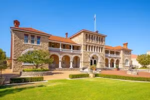 Historic Perth Mint building exterior with sandstone walls and red tile roof.