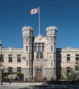 Royal Canadian Mint headquarters building in Ottawa with Canadian flag.