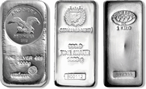 Three 1 kilo silver bars from different mints showing hallmarks and purity stamps.