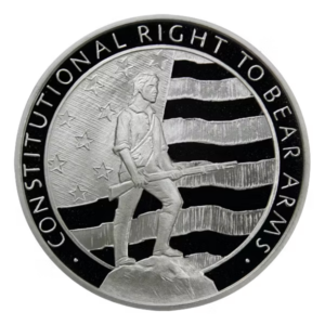 Patriotic silver round depicting Revolutionary War Minuteman with musket against striped flag background and constitutional rights text.