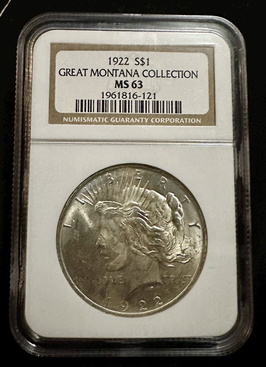 A 1922 Peace silver dollar sealed in an NGC holder and graded MS-63, with the grading label visible above the coin