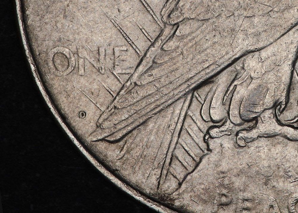 Close-up of a 1922-D Peace dollar reverse with the D mint mark visible below the word ONE and left of the eagle's tail feathers