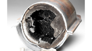 Cutaway catalytic converter showing ceramic honeycomb substrate coated with platinum for emissions reduction
